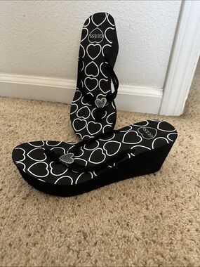 Guess Black Wedge Flip Flops with White Heart Print and Heart Charm